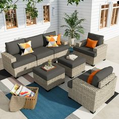 an outdoor living room with grey and orange furniture