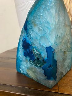 a blue rock sitting on top of a wooden table