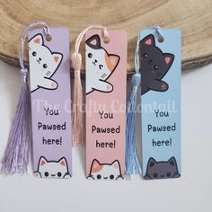 three bookmarks with cats on them and tassels attached to the tags that say, you're passed here