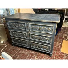 an old dresser is sitting on the floor