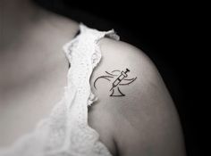 a woman with a small tattoo on her shoulder