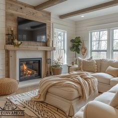 a living room filled with furniture and a flat screen tv mounted on the wall above a fire place