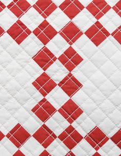 red and white checkered quilting on the back of a tablecloth, close up