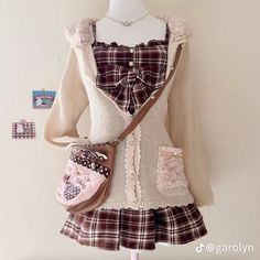 a mannequin wearing a sweater and skirt with purses on it's chest