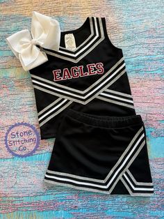 Cute girls cheerleading uniform!  Great for spirit days, pep rallies and sporting events!  This can be customized for your team and is available in multiple color selections.   Set included skirt and shell & mascot embroidered across the front (bow not included).   Uniform Color: black with silver/white trim Embroidery Color: Maroon/White Check out our shop for additional uniform colors and styles! Need something custom?  Message me with your requests! Cheerleading Uniforms, Pep Rally, Cheer Uniform, Cheer Girl, Pom Pom Girl, Team Uniforms, Cheer Team, White Trim, Sport Girl