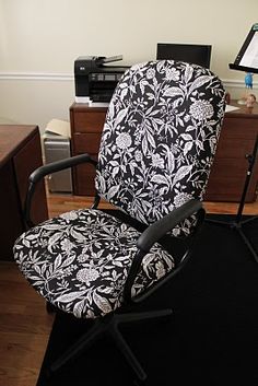 a black and white office chair sitting in front of a computer desk