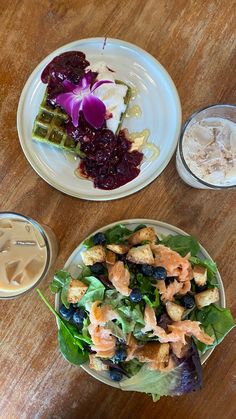 two plates filled with food on top of a wooden table