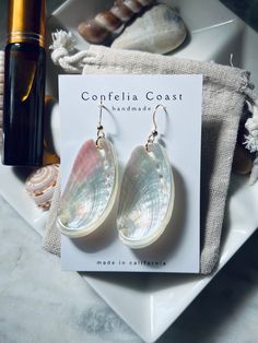 100% Handmade white pearlized mule ear abalone shells are arranged as beautiful drop earrings. They are very lightweight , great for all day wear. These nickel-free earrings feature gold-plated French hook findings for comfort and elegance.  The shells for each pair are hand picked, and are meticulously assembled. These earrings have an organic and minimal look while still being stunningly eye catching , they are truly versatile for any occasion. Would even make a beautiful addition to a beach b Beachy Earrings, Wardrobe Goals, Beach Bridal, Nickel Free Earrings, Free Earrings, Beach Inspired, Shell Earrings, Abalone Shell, Hand Picked