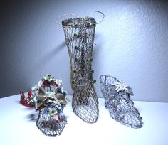 three wire vases sitting next to each other on a table