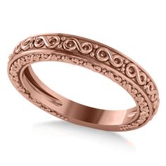 a rose gold wedding ring with filigrees on the sides and an engraved inscription