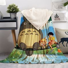 a blanket with an image of pooh and tiki on it next to some pillows