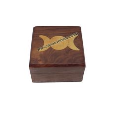 a small wooden box with two crescents on the front and one in the middle