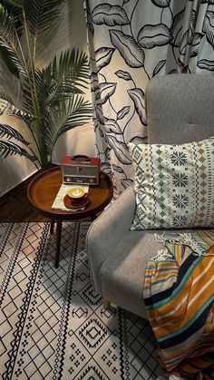 a living room with a couch, coffee table and potted plant