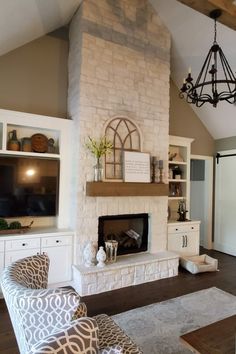 a living room filled with furniture and a flat screen tv mounted on a wall above a fireplace