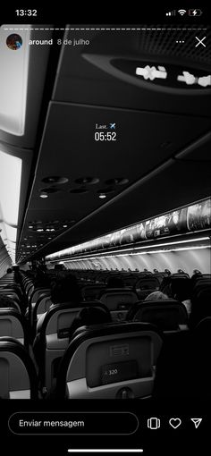 black and white photo of an airplane with seats on the side, looking up at the ceiling