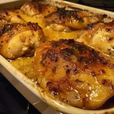 some chicken is in a baking dish on the stove