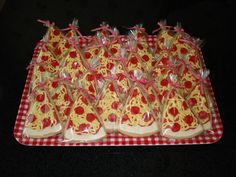 there are many pieces of pizza on the trays that have been wrapped in cellophane