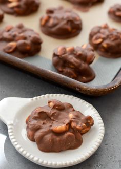 chocolate cookies are on a plate next to a baking pan