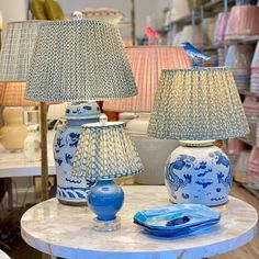 two blue and white lamps sitting on top of a table