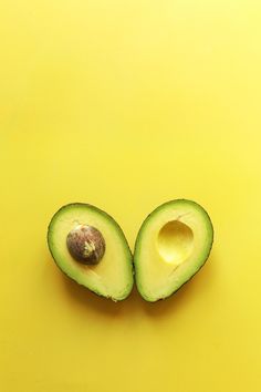 an avocado cut in half on a yellow background with the words flavor of august above it