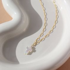 Add a touch of elegance and spirituality to your outfit with our Mother of Pearl Cross Necklace. This unique piece features a stunning cross-shaped charm made from mother of pearl, symbolizing purity and protection. The delicate cosette chain completes the look, making it perfect for any occasion. DETAILSAvailable in 16" or 18" lengthsAvailable in 14k Gold Fill and Sterling SilverHypoallergenic and nickel freeWe recommend removing pearls before showering, swimming or sleeping to keep them shinin White Cross Pendant Necklace With Clavicle Chain, White Cross Necklace With Clavicle Chain, Cross Necklace With Pearl Charm As Gift, Cross Necklace With Pearl Charm For Gifts, Pearl Charm Cross Necklace For Gift, Gift Pearl Charm Cross Pendant Necklace, Cross Necklace With Pearl Charm, White Cross Necklace With Medium-length Chain, White Cross Pendant Clavicle Necklace