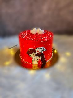 a red cake with two hearts on it