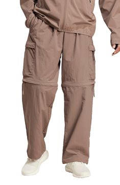 Lightweight and relaxed, these pants made of recycled nylon feature plenty of roomy pockets plus zip-off legs for easy conversion to cargo shorts. 27 1/2" inseam; 20" leg opening; 12 1/2" front rise; 15 1/2" back rise (size Medium) Elastic/drawcord-toggle waist Side-seam pockets; cargo zip envelope-patch pockets Zip-off legs allow an easy transition from pants to shorts as temps change Drawcord-toggle cuffs 100% recycled nylon Machine wash, tumble dry Imported Pants To Shorts, City Escape, Loose Fit Pants, Adidas Sportswear, Athletic Apparel, Athletic Outfits, Workout Pants, Short Pants, Adidas Men