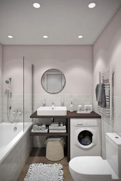 a bathroom with a sink, toilet and washer in it's center area