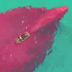 a boat floating on top of a large pink substance