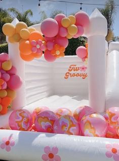 an inflatable pool with balloons and decorations