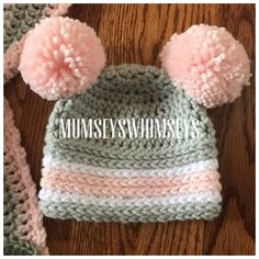 a crocheted hat with two pom poms on top and the words mumseys whimseys above it