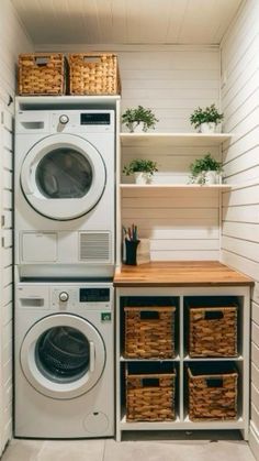 a washer and dryer in a small room with baskets on the shelf next to it