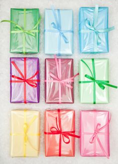 six different colored gift boxes tied with ribbons