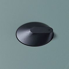 a round black object on a gray surface