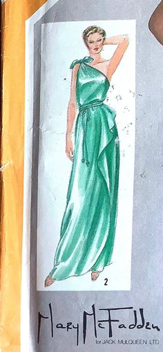 a drawing of a woman in a green dress is on the side of a piece of paper