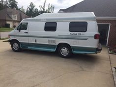 a white van parked in front of a house