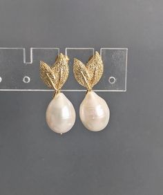 "Baroque Pearl Gold Leaf Stud Earrings, Teardrop Pearl Earrings, Bridesmaid Earrings, Wedding Earrings, June Birthstone, which measure approx. 10x15mm.   These earrings measure approx. 1.1\" ( 27 mm.)  Nice jewelry gift.  * Processing time is 3 - 5 days.  * US orders are shipped first class mail. * International orders are shipped first class international. * Shipping upgrades are available at checkout. Thank you for visiting GlamorousJewelry1" Elegant Teardrop Crown Matching Earrings Jewelry, Elegant Jewelry With Teardrop Crown Matching Earrings, Elegant Jewelry With Matching Teardrop Crown Earrings, Elegant Teardrop Crown Earrings For Wedding, Elegant Anniversary Drop Earrings, Elegant Gold Pear-shaped Bridal Earrings, Elegant Teardrop Crown Earrings As Gift, Formal Teardrop Bridal Clip-on Earrings, Elegant Pear-shaped Teardrop Earrings As Gift