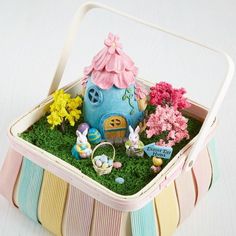 a small toy house with flowers and plants in it