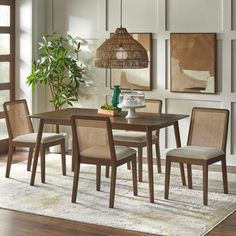 a dining room table with four chairs around it