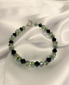 Classic Green Black Dainty beaded bracelet with toggle clasp Perfect gift for your mom, daughter, girlfriend, wife, best friend, for any occasion, Birthday, Wedding, Christmas, New Year, Valentine's Day, Anniversary, Friendship, Holiday, Graduation Gift. This beautiful handmade piece is ready to ship.  Materials Used: Wire, Toggle Clasp, crimp beads, bottle green beads, black beads, silver toggle How to Measure your size:  1. Wrap a measuring tape around your wrist. 2. Add 1/2 inch to 1 inch. For example, if your wrist size is 7 inches, add one inch, so 8 inches bracelet length will fit you well. A similar design can be custom made to your preference. Please feel free to send me a message and we can work on creating a beautiful bracelet for you or your loved ones.  Thank you for visiting m Green And Black Jewelry, Cheap Green Beaded Bracelets For Birthday, Affordable Handmade Green Friendship Bracelets, Green And Black Bracelet, Adjustable Crystal Bracelet With Lobster Clasp For Party, Elegant Beaded Crystal Bracelet For Birthday, Green Beaded Bracelets With Lobster Clasp As Gift, Friendship Bracelets Green, Green Bracelet Beads