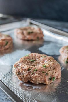 hamburger patties on a baking sheet ready to go into the oven