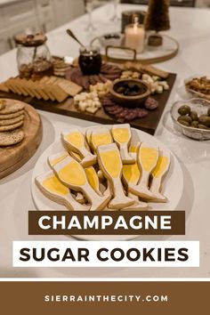 champagne sugar cookies on a table with wine glasses and crackers in the background text reads champagne sugar cookies