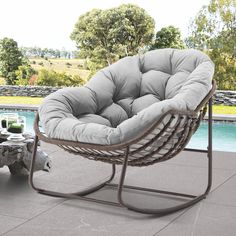 a chair sitting on top of a patio next to a pool