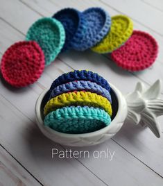 crocheted dishcloths in a bowl on a white table