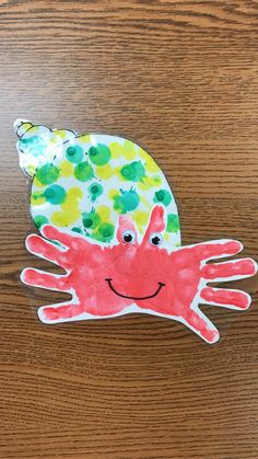 a handprinted crab on a wooden surface