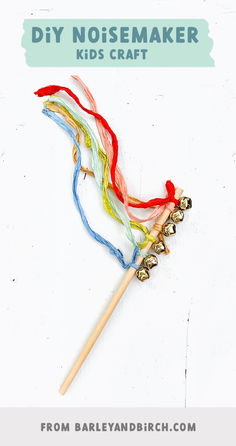 a wooden stick with colorful yarn on it and the words diy noisemaker kids craft