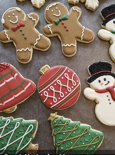 decorated christmas cookies are arranged on a table