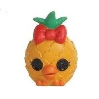 a yellow toy with a red bow on it's head and an orange pineapple