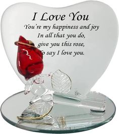 a heart shaped glass with a red rose on it and the words i love you