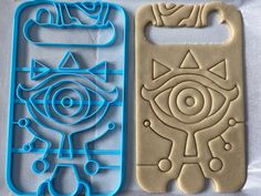 two cookie cutters with designs on them sitting next to each other